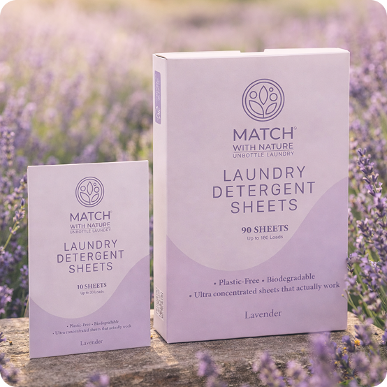 Two boxes of Match with Nature laundry detergent sheets in a lavender field