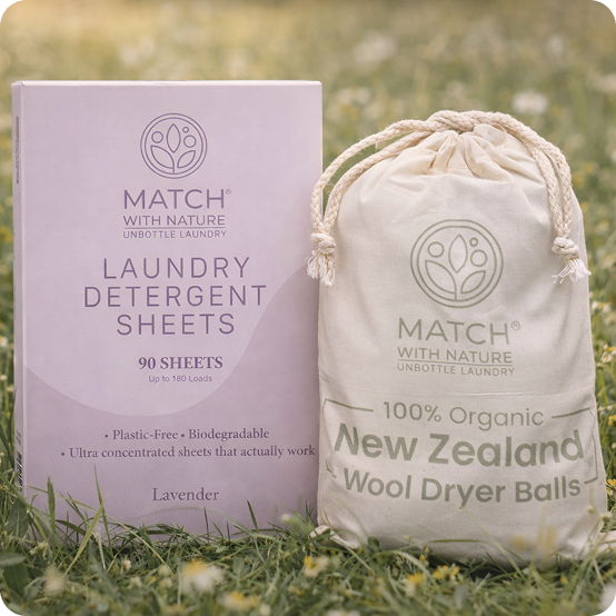 Match with Nature laundry detergent sheets and wool dryer balls packaging on grass