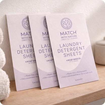 Three packages of Match with Nature laundry detergent sheets on a wooden surface.