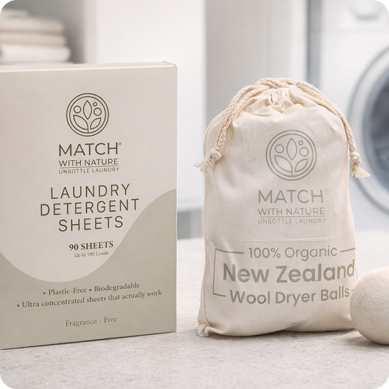 Match with Nature laundry detergent sheets packaging and wool dryer balls on a neutral background