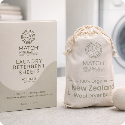 Match with Nature laundry detergent sheets packaging and wool dryer balls on a neutral background