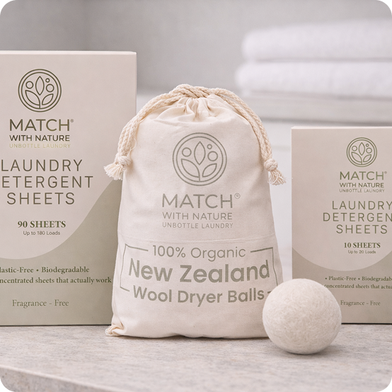 Organic laundry products including dryer balls and detergent sheets from Match with Nature on a neutral background.