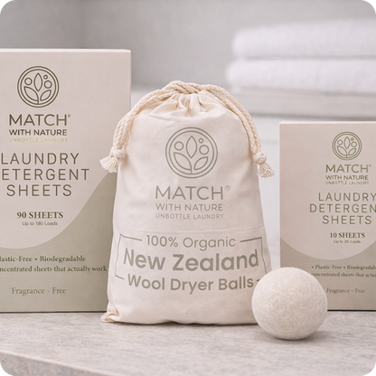 Organic laundry products including dryer balls and detergent sheets from Match with Nature on a neutral background.
