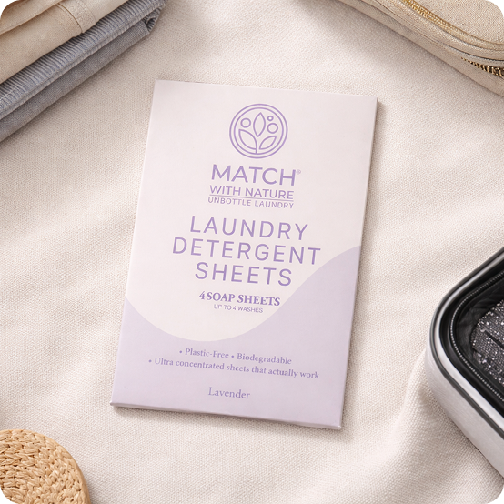 Package of Match with Nature laundry detergent sheets on a beige fabric background