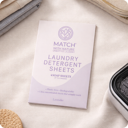 Package of Match with Nature laundry detergent sheets on a beige fabric background