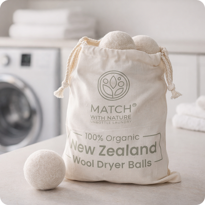 Bag of 100% organic New Zealand wool dryer balls with a washing machine in the background.