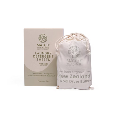 Match with Nature laundry detergent sheets packaging and wool dryer balls on a white background